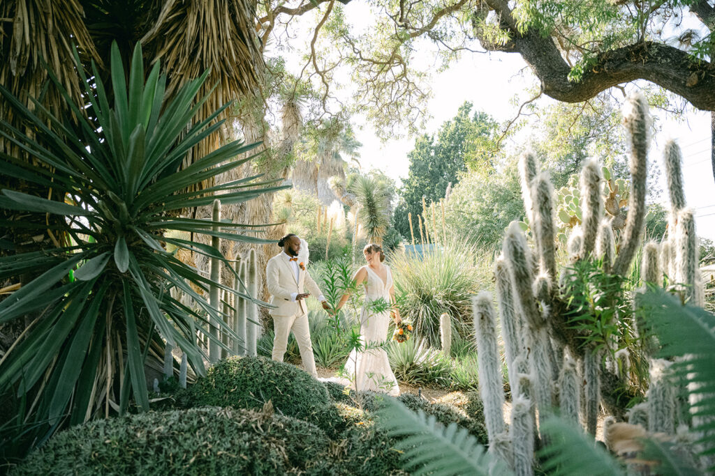 Bride and groom walk hand and hand through walnut creek ruth bancroft garden