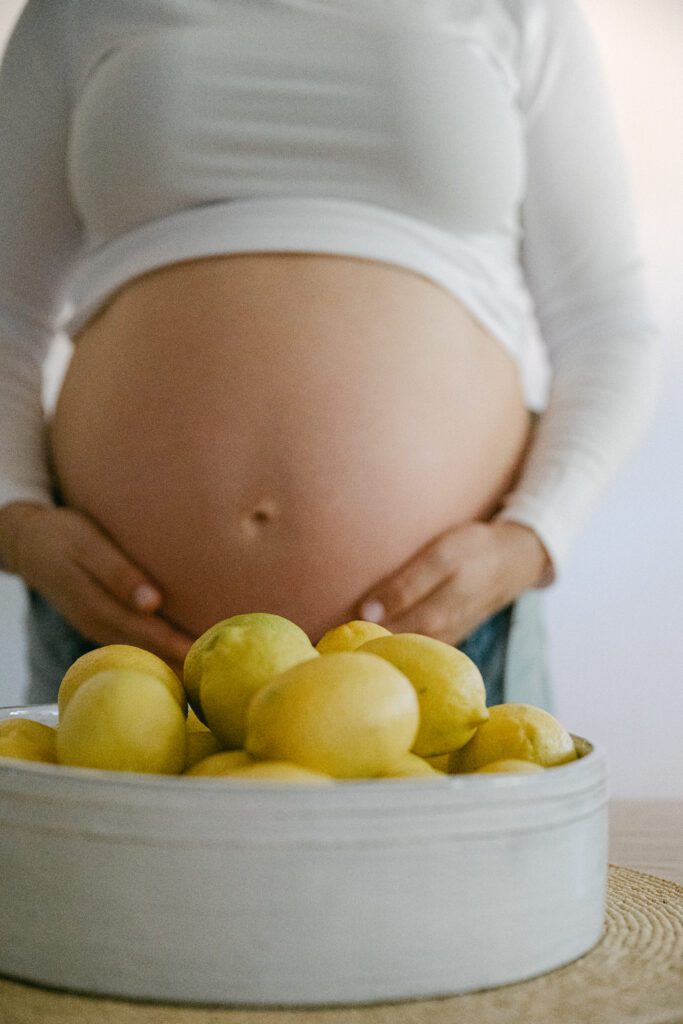 Intimate at-home maternity session with cozy setting lemon bowl