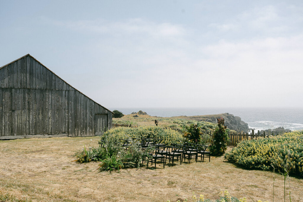 Ceremony with wild blooms set at the sea ranch cliffs for a wedding