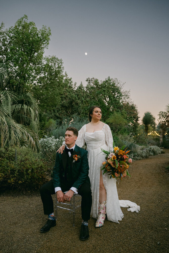 bride and groom seated at sunset in walnut for wedding portrait