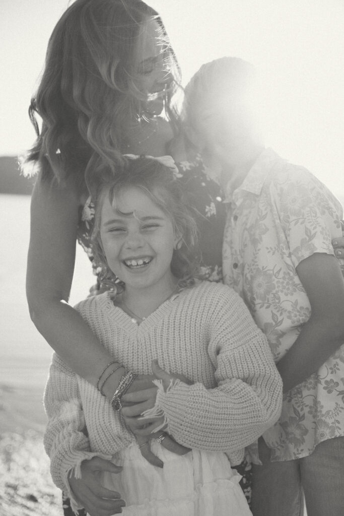 mother hugging two children at beach during San Francisco Bay Area family photography session