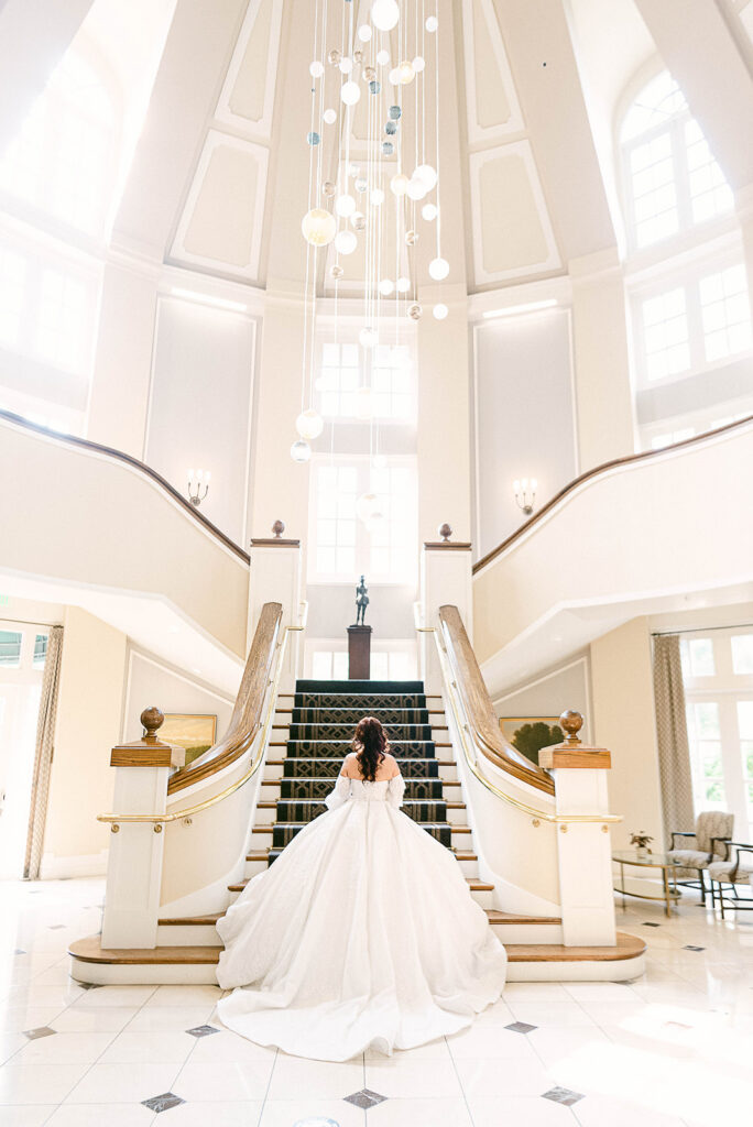 Bride walking upstairs while getting ready for her wedding